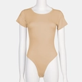 Detail view of the crewneck short sleeve bodysuit with slim fit on a mannequin - Apricot