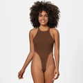 Detail of deep brown ribbed halter bodysuit with high cut leg design in a studio shot - S / Brown