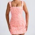 Detailed view of 3D pink floral applique and texture on the backless cocktail dress - Coral