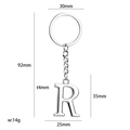 Polished silver metal keychain featuring a large capital R letter pendant charm - Letter R