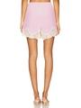 Women's pink satin pajama shorts with eyelash lace hem shown from a rear view - S / Pink