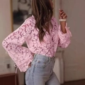 Detail of pink floral lace long sleeve top with bow cuff and light blue denim jeans - S / Pink