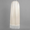 Detailed view of champagne satin skirt featuring delicate white eyelash lace trim at the hem - S / Apricot
