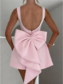 Macro detail of a pink open-back dress featuring white pearl piping and a large bow design - S / Dresses / Pink