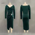 Detail view of emerald green velvet dress with side ruching and rhinestone buckle accent - Dresses / S / Green