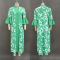 Detail of green floral maxi dress with puff sleeves and ruffled cuffs on a mannequin - Green / L