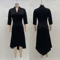 Detail of elegant black V-neck satin midi dress with asymmetrical hem and long sleeves - S / Dresses / Black