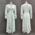 Detail of light green floral V-neck dress with pleated waist and lantern sleeves - S / Dresses / Light Green