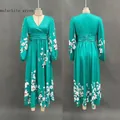 Detail of malachite green V-neck pleated dress with white floral prints and long sleeves - S / Dresses / Malachite green