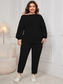 Detail of plus size black two-piece lounge set featuring off-shoulder top and fitted pants - XL / Black