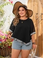 Detail of plus size black top featuring sequined hem and sleeve edges in outdoor setting - 1XL / Black