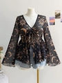 Detail of V-neck mesh top with bohemian sun and moon prints and front tie closure - Black Galaxy