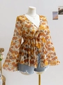 Detail of V-neck floral chiffon top featuring tie-up bow and elegant bell sleeves - Yellow Sunflower