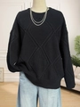 Detailed view of black diamond-pattern knit sweater with ribbed cuffs and hem texture - One Size / Black