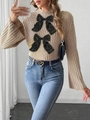 Detail of beige knit sweater with black satin bows and bell sleeves paired with denim - S / Tops / Khaki