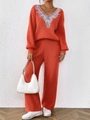 Detail of orange V-neck knit sweater featuring silver feather embroidery on the neckline - S / Top And Bottom / Orange