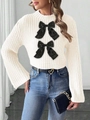 Detail of cream knit sweater featuring large black satin bows and ribbed texture - S / Tops / White