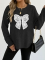 Detail of black knit sweater featuring a white lace butterfly applique and crew neckline - S / Black