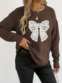 Detail of white lace butterfly embroidery on a brown long sleeve crewneck knit sweater - Coffee