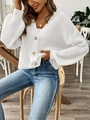 Close-up of white chunky knit cardigan featuring large brown buttons and textured weave - S / White