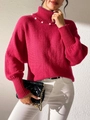 Gros plan sur un pull col roulé rose fuchsia avec perles blanches et texture côtelée - S / Rose Rouge