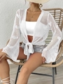 Detail of white crochet knit cover-up showing bell sleeves and tie-front bow closure - One Size / White