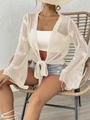 Primer plano de cárdigan beige de ganchillo con mangas acampanadas y lazo frontal - Talla única / Tops / Albaricoque Claro