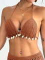 Close-up of handmade crochet bikini top with white sea shells and halter neck design - One Size / Brown