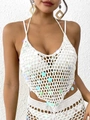 Close-up of white crochet beach top featuring iridescent sequins and intricate hand-knit patterns - White