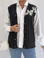 Detail of black cable-knit vest featuring white 3D floral accents and button-down front - One Size / Tops / Black