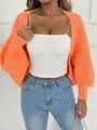 Close-up of bright orange chunky knit cardigan with balloon sleeves and gold chain bag - One Size / Tops / Orange