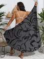 Nahaufnahme eines leichten Übergroße-Sarongs mit abstraktem Spiraldruck am Strand - Schwarze Kalligraphie Stil