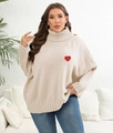 Close-up of red heart embroidery on the thick beige oversized knit turtleneck sweater - Apricot