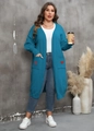 Detail of red heart patch on blue oversized cardigan with knitted pockets - Teal