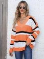 Close-up of V-neck knitted sweater with orange and white stripes and drop shoulder texture - One Size / Orange