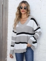 Detail showing the white grey and black striped V-neck sweater on a casual model - One Size / Gray