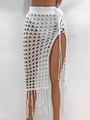 Detail of white crochet beach skirt with hollow-out pattern, high side slit and long tassels - S / Bottoms / White