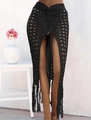 Detail of black crochet beach skirt featuring hollow knit patterns and long fringe tassels - S / Bottoms / Black
