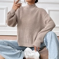 Close-up of mock neck knit sweater featuring thick ribbed texture and drop shoulders - S / Apricot