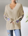 Dettaglio di fiori colorati 3D fatti all'uncinetto sulle maniche del maglione beige - S / Albicocca