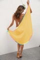 Detail of bohemian yellow beach cover-up with multi-color pom-pom tassels on light fabric - One Size / Bottoms / Yellow
