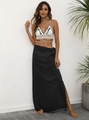 Detail of crochet halter top with white shell tassels and black fringe wrap skirt - One Size / Bottoms / Black