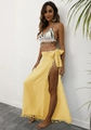 Detail of yellow wrap beach skirt with delicate fringe trim and bohemian side-tie design - Yellow