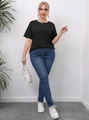 Close-up detail of a plus size black cotton T-shirt and slim fit dark blue denim jeans - 0XL/L / Black