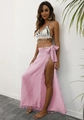 Detail of crochet bikini top with shells and pink sarong with tassel fringe accents - Pink