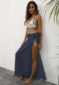 Detail of bohemian beach wrap skirt with fringe balls and white crochet shell top - Navy Blue