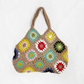 Detailed view of colorful crochet granny square patches on a handmade tote bag surface - Khaki