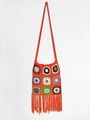 Detail of handmade crochet shoulder bag featuring colorful floral squares and long tassels - Orange