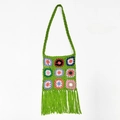 Detail of green handmade crochet shoulder bag featuring colorful granny square patterns - Green