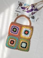 Close-up of handmade granny square crochet tote bag with colorful patchwork patterns - Brown / One Size